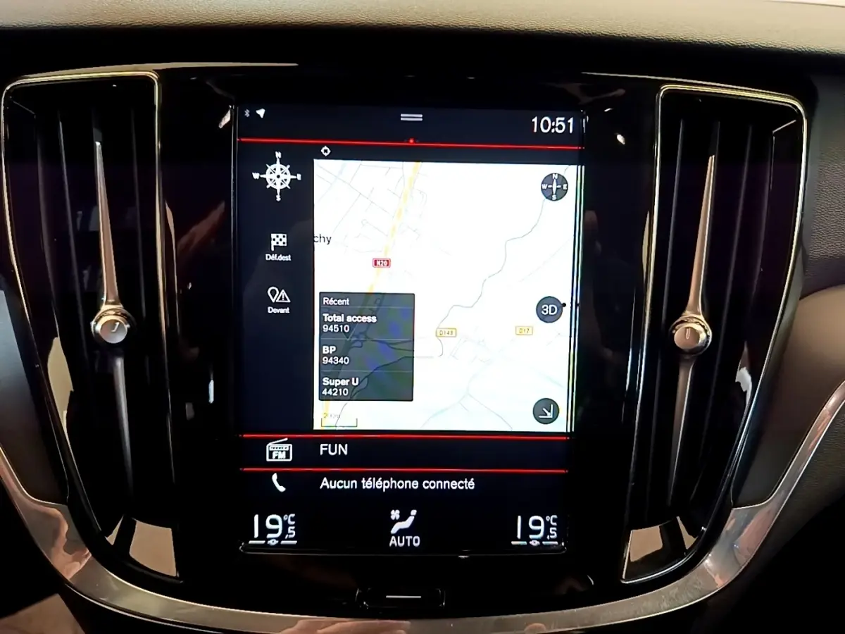 Écran tactile central du tableau de bord noir de la Volvo V60 2020 affichant la navigation 3D et la climatisation.