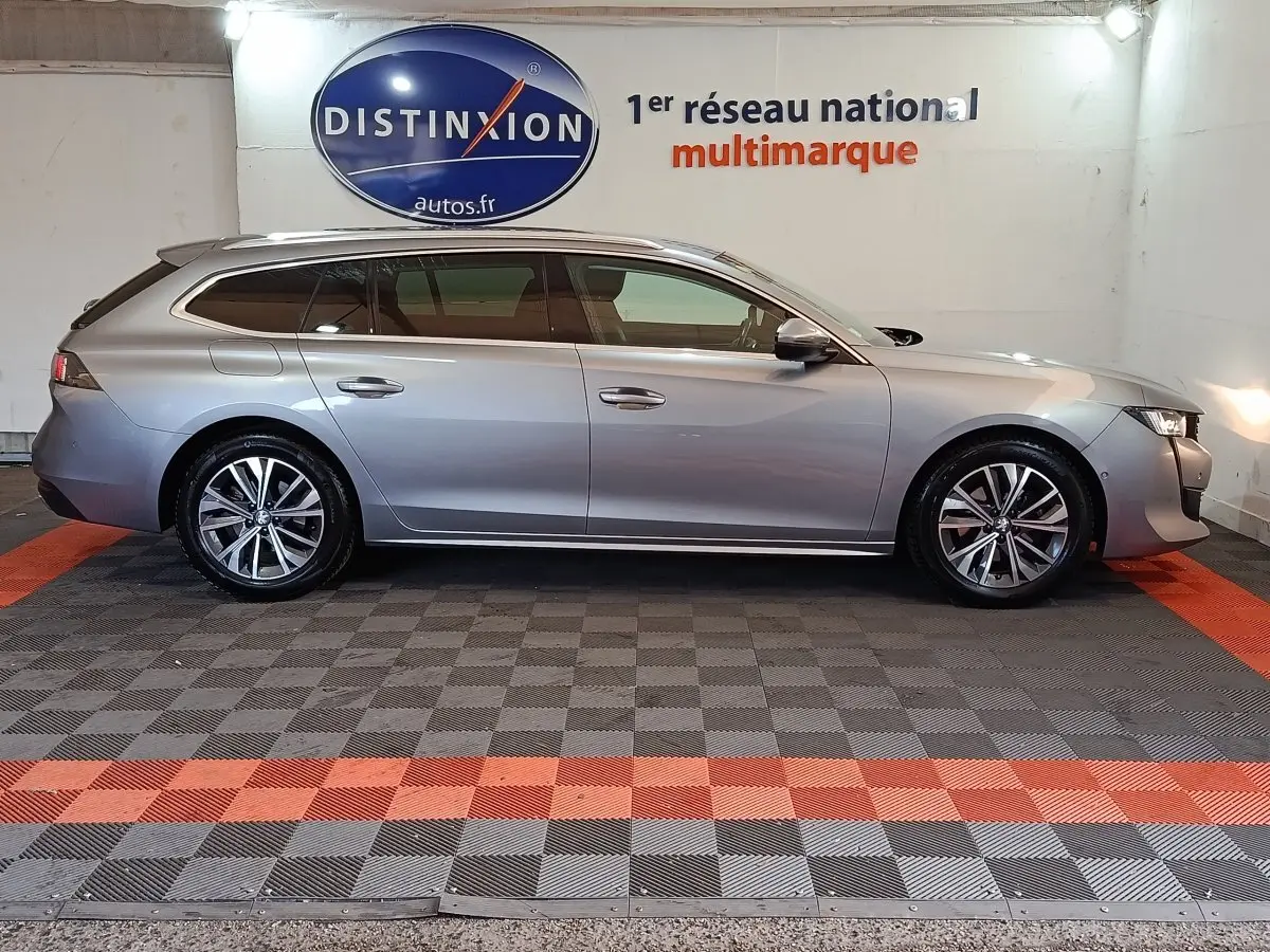 Peugeot 508 BlueHDi 130 break gris clair vue de profil côté gauche, jantes alliage et toit panoramique.