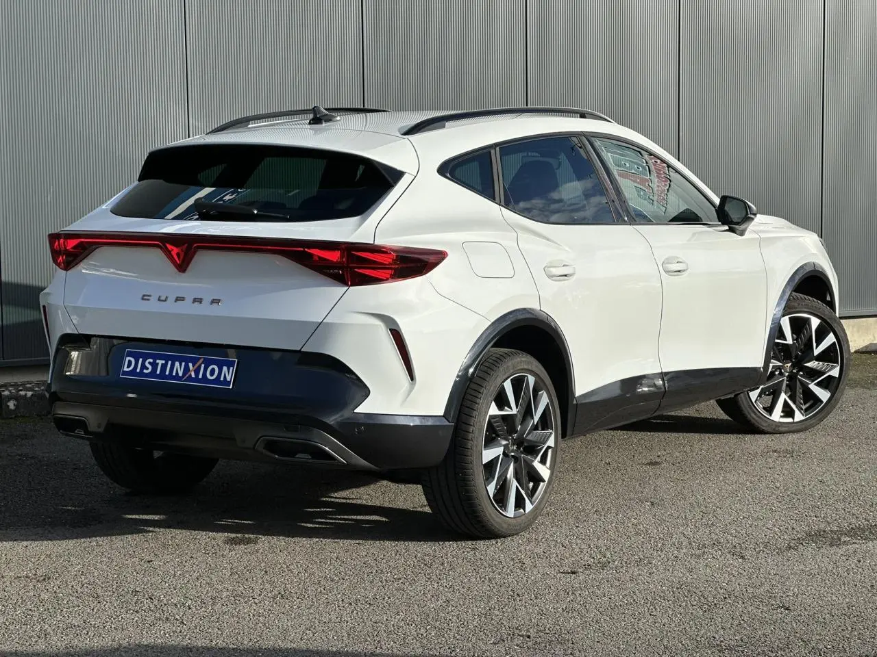 Vue 3/4 arrière droite du CUPRA Formentor blanc Neige avec feux arrière Tri-LED et jantes alliage 19'' Sandstorm.