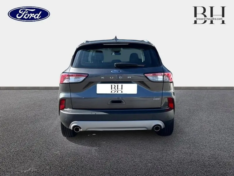 Vue arrière du Ford Kuga 2022 gris Magnetic métallisé avec double sortie d’échappement et feux LED distinctifs.