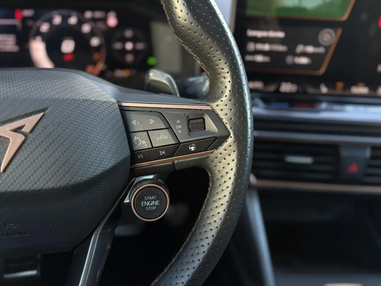 Gros plan sur le volant cuir perforé noir avec logo CUPRA cuivré et commandes intégrées du Formentor 2025.