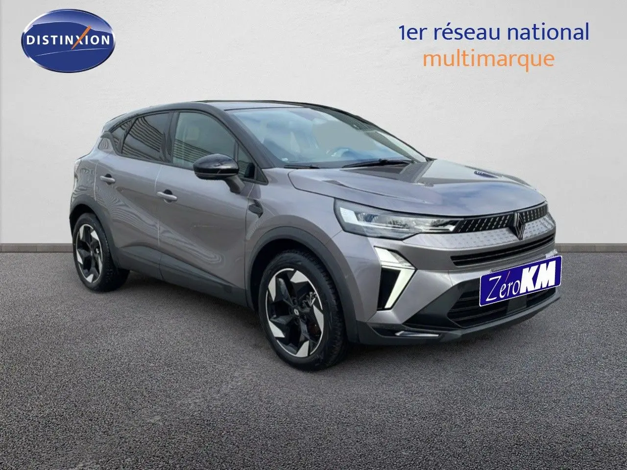 Renault Captur E-Tech hybride gris Cassiopée métal, vue 3/4 avant côté gauche avec toit noir et jantes bicolores.