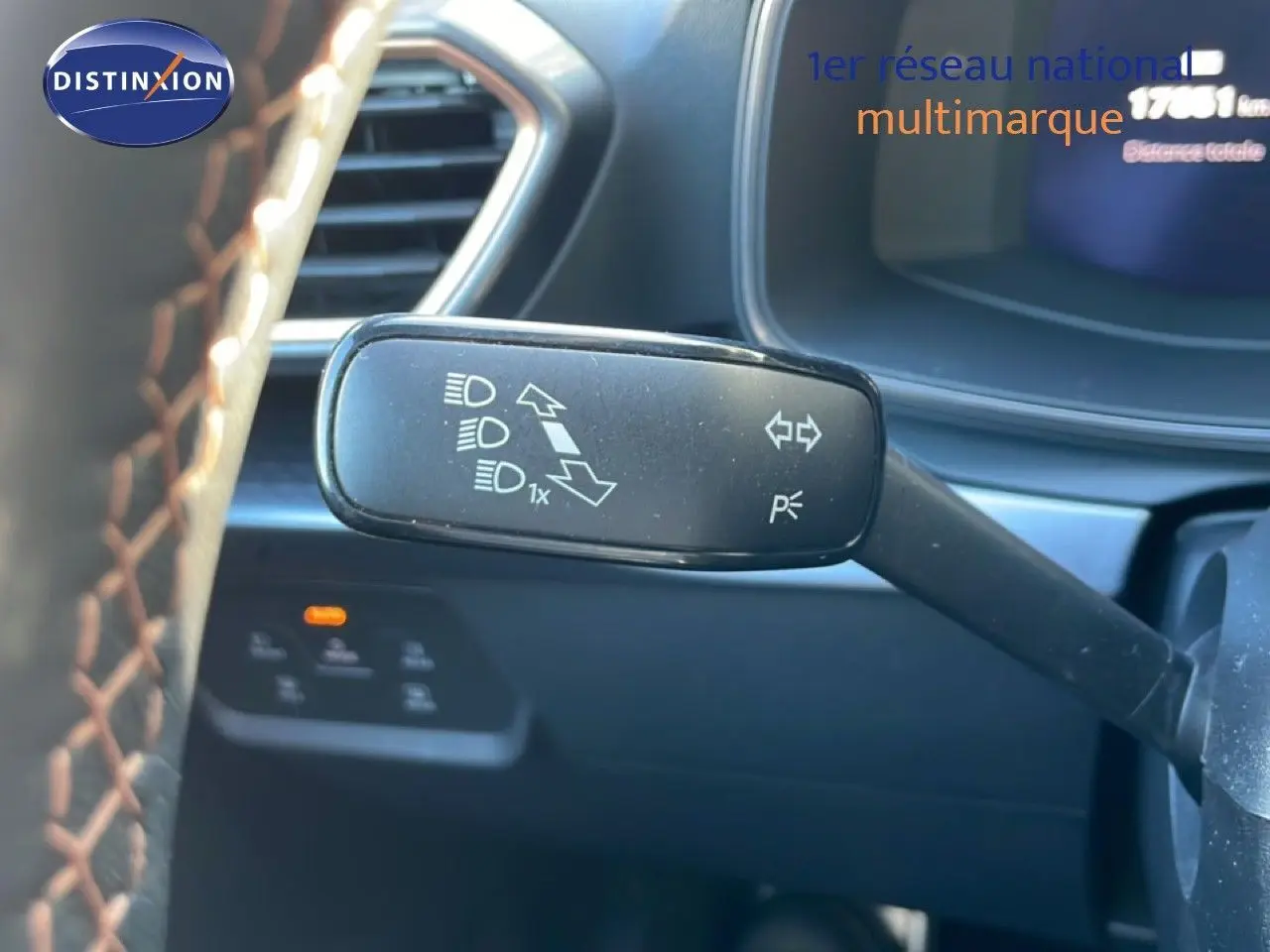 Gros plan sur la manette de clignotant à gauche du volant d’une CUPRA Leon 1.5 eTSI 150CH DSG 2025, intérieur noir.