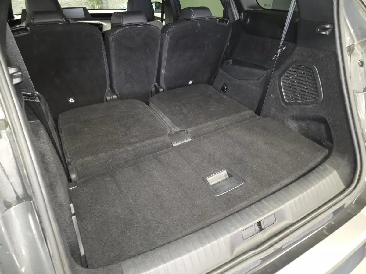 Vue arrière du coffre du Peugeot 5008 gris avec banquette rabattue et habillage intérieur noir.