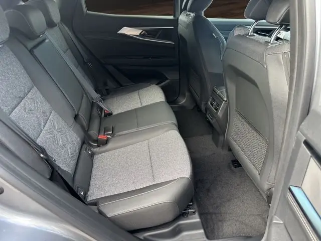 Vue intérieure arrière droite des sièges arrière en tissu gris et cuir noir du Renault Austral PH2 Techno E-Tech Full Hybrid 2025.