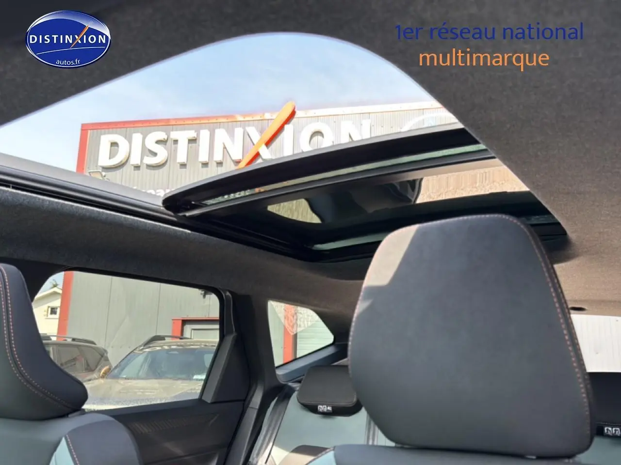 Vue intérieure du toit ouvrant panoramique et des sièges avant du Dacia Bigster gris schiste, avec ciel visible à travers le toit.