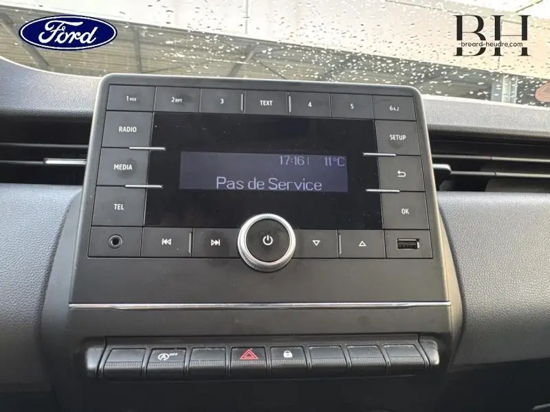 Tableau de bord avec écran radio affichant "Pas de Service" dans un véhicule Renault Clio blanc, vue frontale rapprochée.