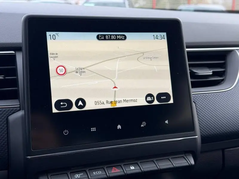 Écran tactile central du tableau de bord du Renault Arkana 2025 montrant la navigation GPS avec carte et indications.