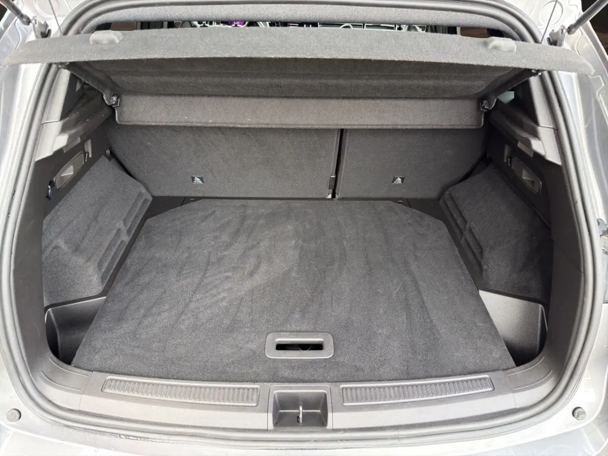 Vue plongeante sur le coffre gris foncé du Renault Austral 2025, avec banquette arrière rabattue et cache-bagages visible.