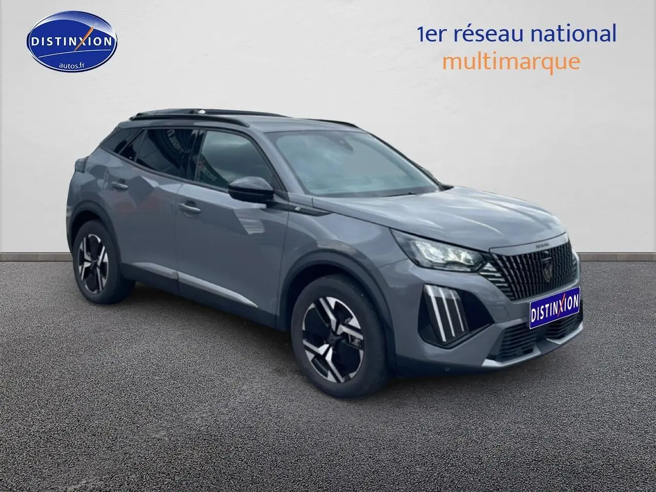 Peugeot 2008 E-136 allure gris sellenium en 3/4 avant droit avec jantes alu et barres de toit noires.