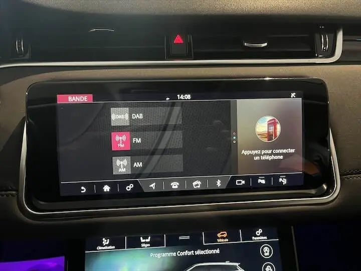 Écran tactile central du tableau de bord du Range Rover Evoque noir Santorini, affichant les options radio DAB, FM et AM.