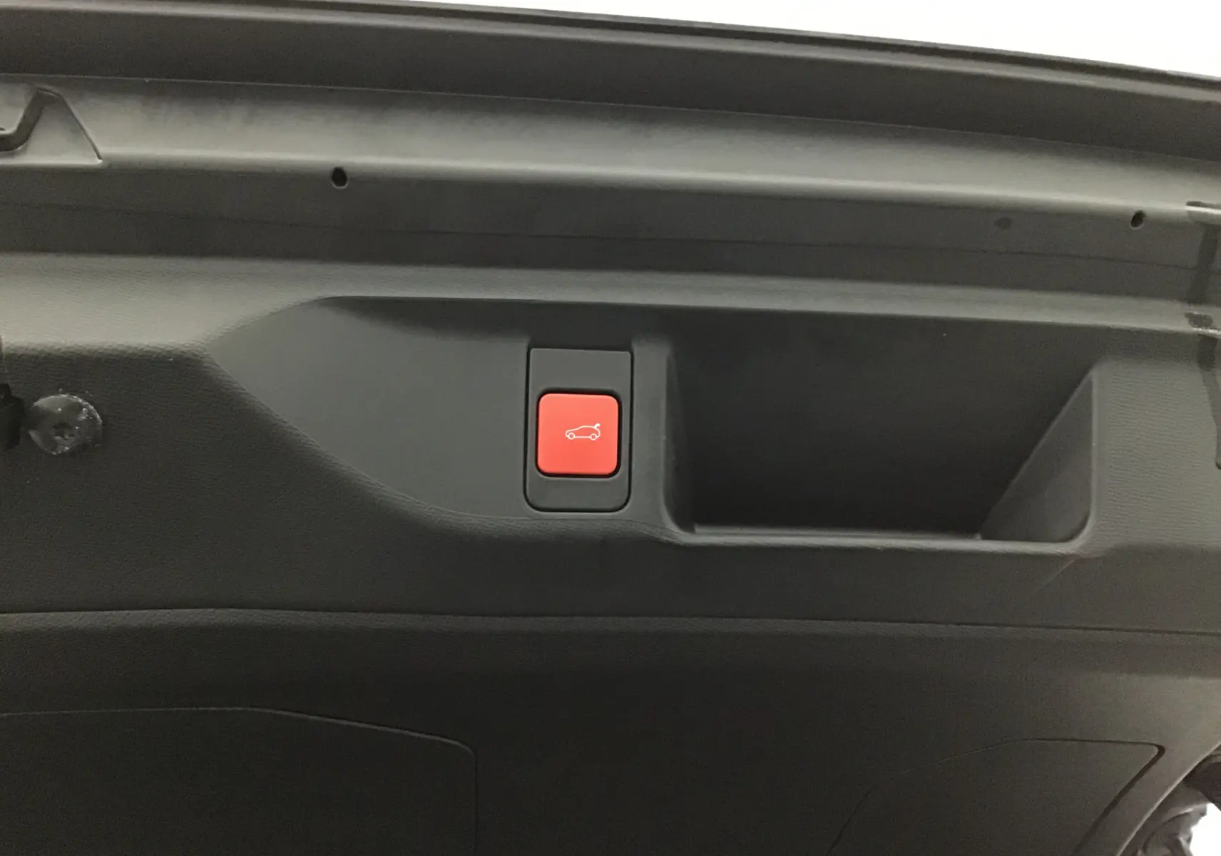 Bouton rouge d'ouverture électrique du coffre dans le hayon intérieur d'un DS4 noir 2022 Cross Rivoli.