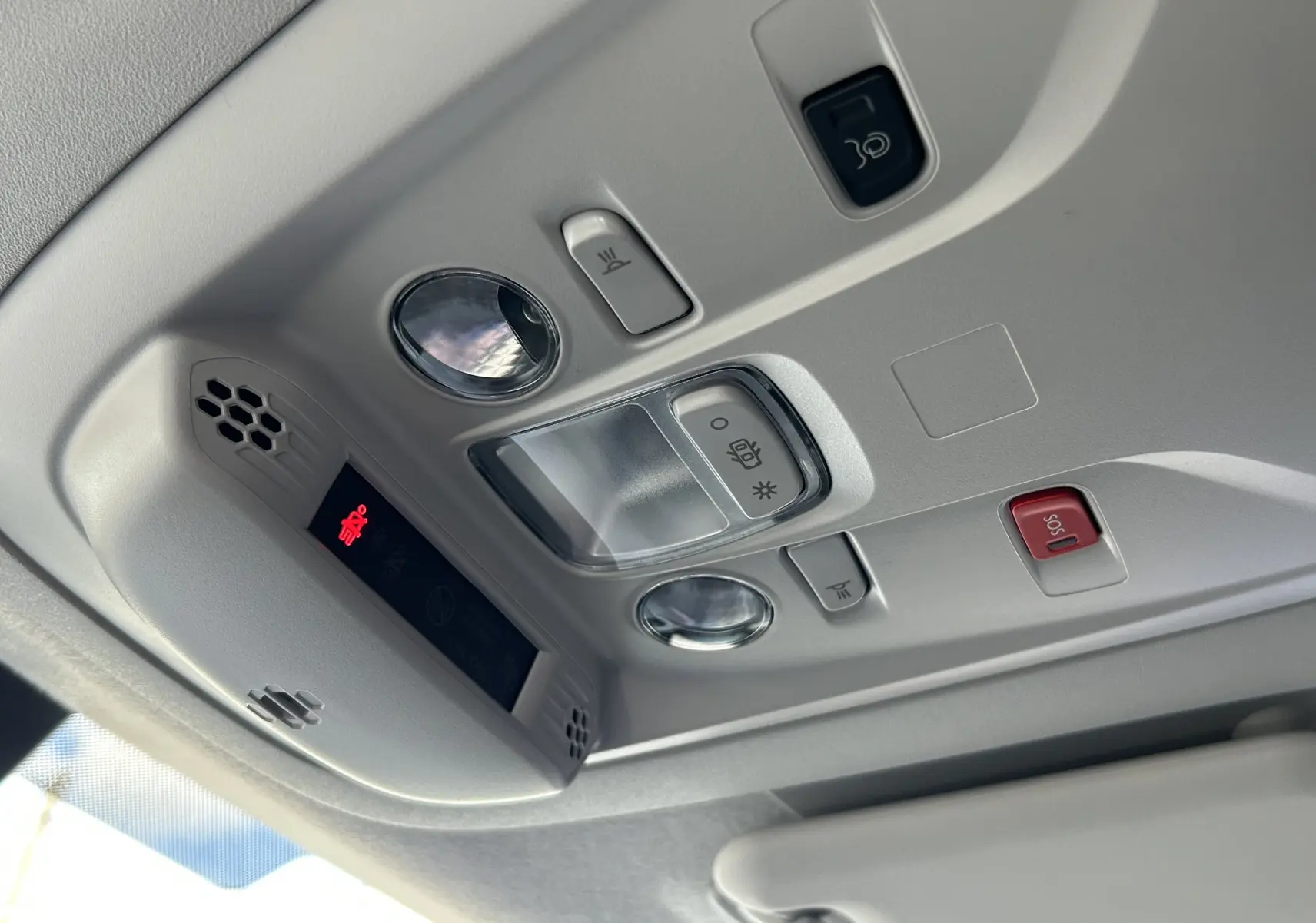 Plafonnier intérieur gris clair du Peugeot Partner Fourgon 2025 avec boutons de lumière et alerte SOS rouge.