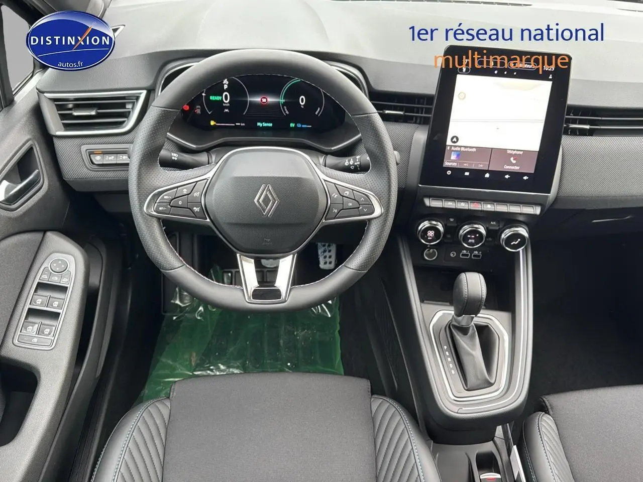 Intérieur avant de la Renault Clio V noir étoile, vue du tableau de bord avec volant multifonction et écran tactile vertical.