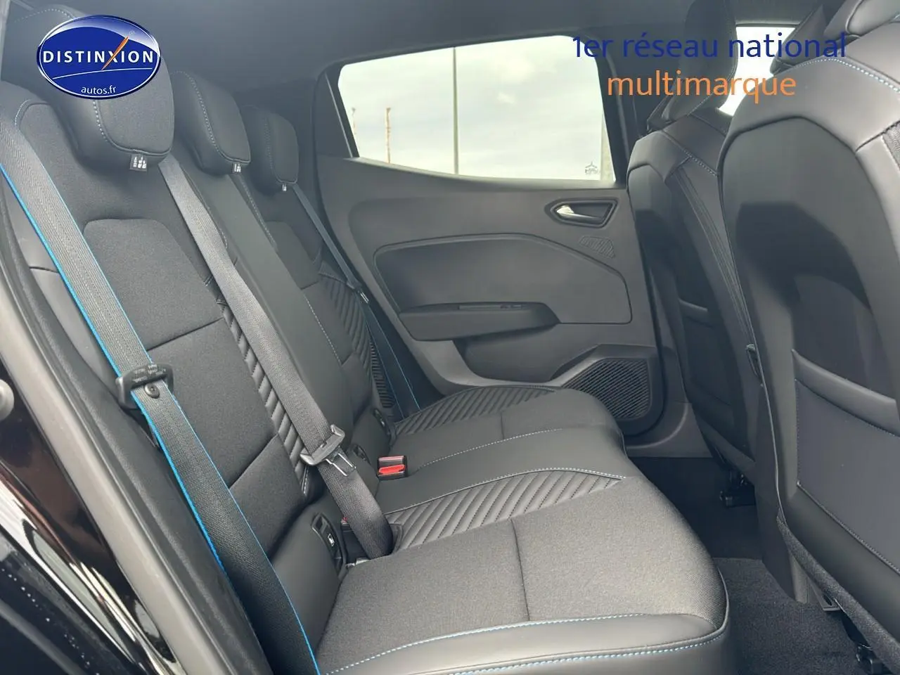 Banquette arrière vue côté gauche de la Renault Clio V noire étoile esprit Alpine avec surpiqûres bleues.