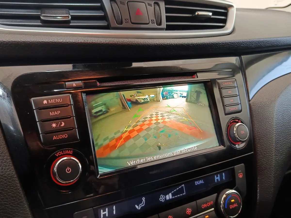 Écran tactile central du Nissan Qashqai 2019 gris clair montrant l'aide au stationnement arrière en intérieur.