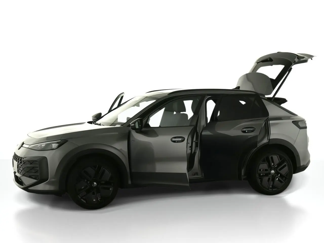 Volkswagen T-Roc gris Loup vue de profil gauche avec portes avant et arrière ouvertes et coffre relevé.