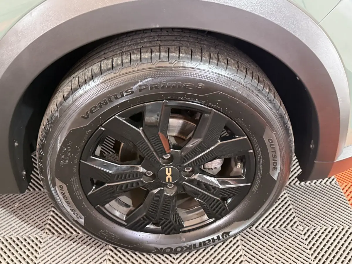 Gros plan sur la roue avant droite noire à jante alliage du Dacia Sandero Extreme+ vert 2024.