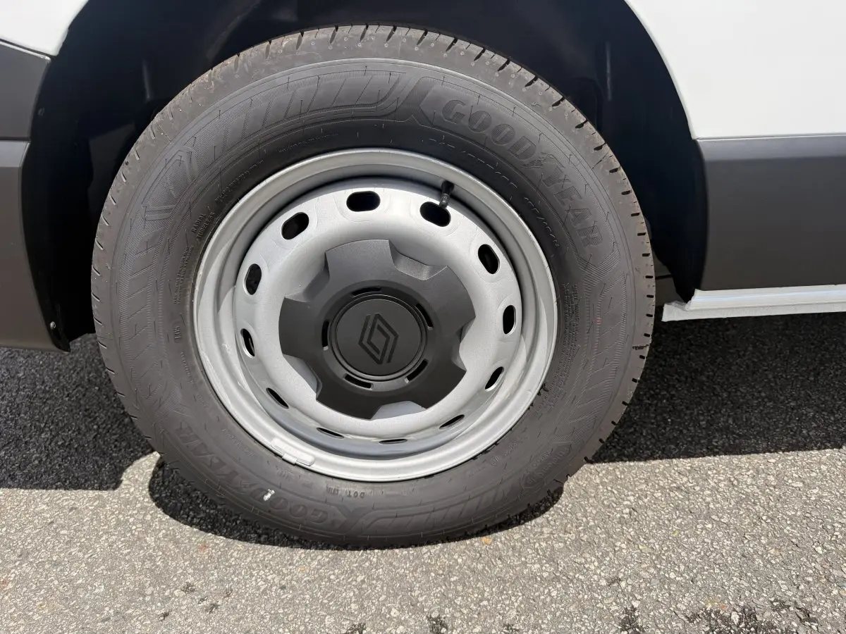 Gros plan sur la roue avant droite du Renault Trafic Fourgon blanc avec jante acier et logo Renault central.