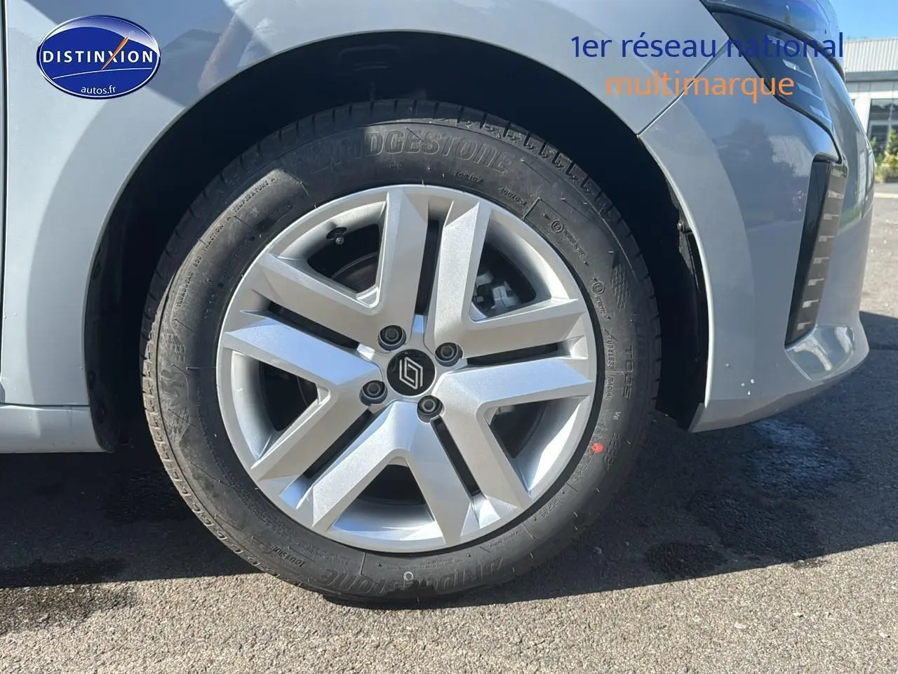 Gros plan sur la roue avant gauche de la Renault Clio 2025 en Gris Rafale avec jante alliage argentée.