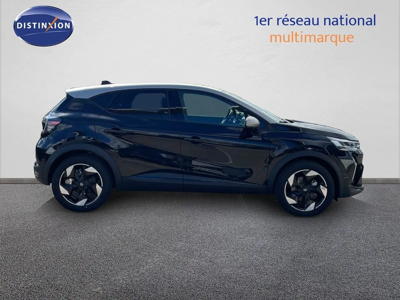 Profil latéral droit du Renault Captur E-Tech hybride 2025 noir étoile avec toit gris et jantes stylisées.