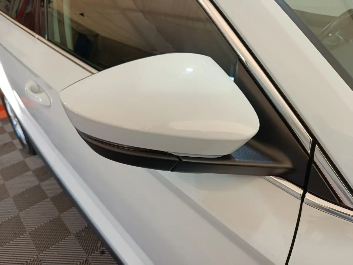 Rétroviseur droit blanc du Skoda Karoq 2024, vue rapprochée sur la portière côté passager.