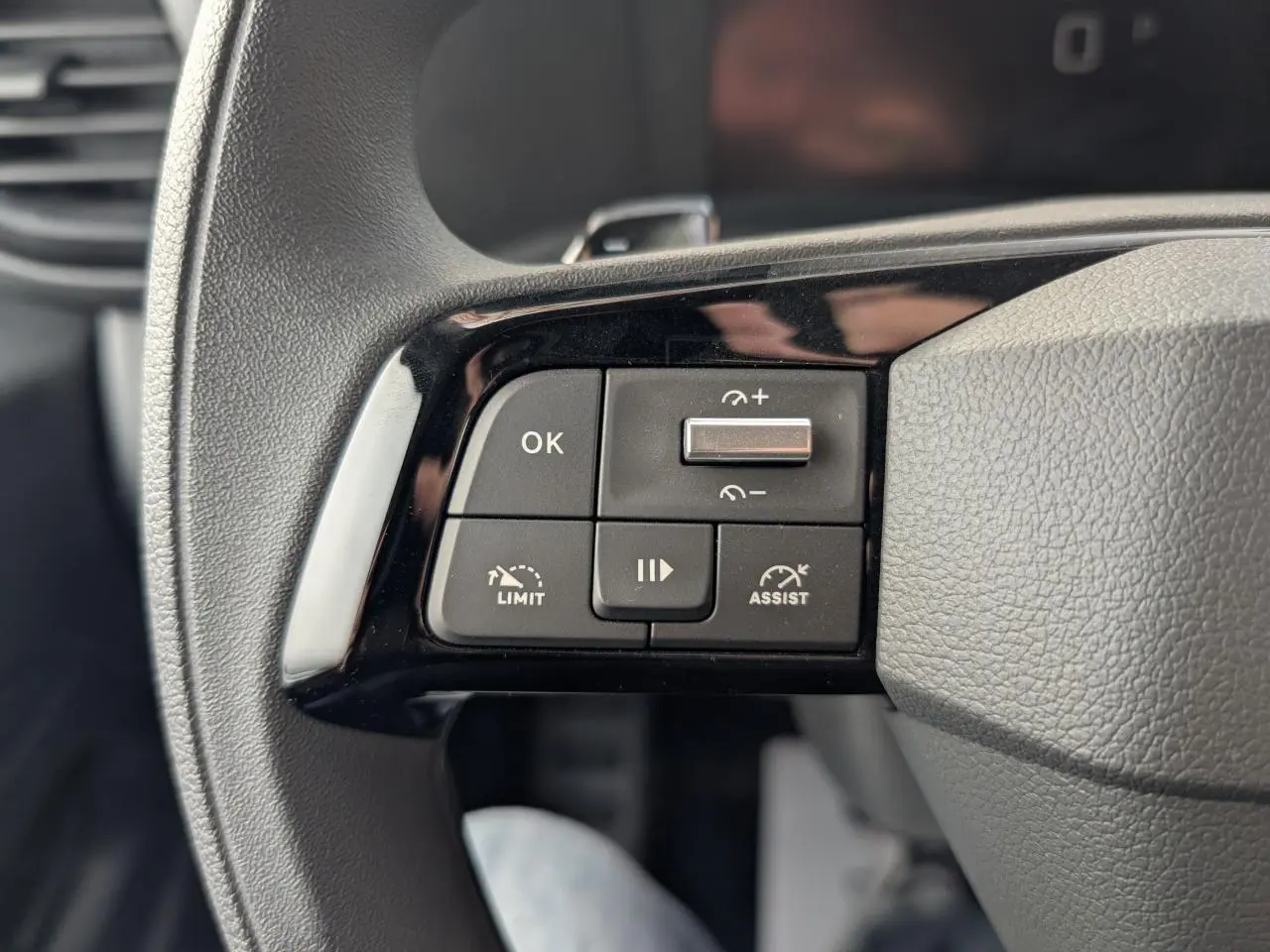 Gros plan sur les commandes de régulateur et limiteur de vitesse sur le volant noir du Peugeot Expert Fourgon 2025.