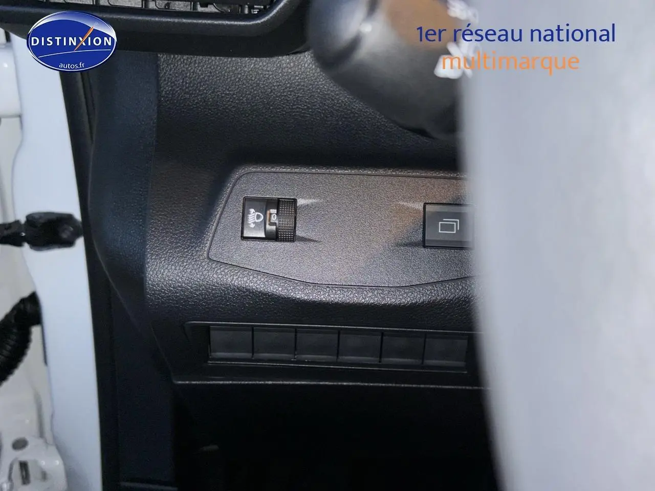 Détail du tableau de bord côté gauche du Citroën Berlingo Fourgon blanc 2025 avec commande de réglage des phares.