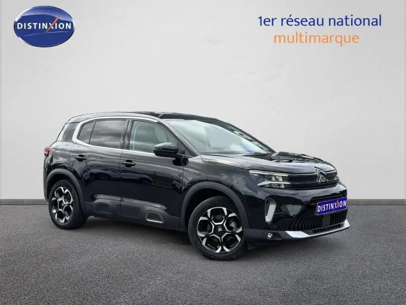Citroën C5 Aircross noir Perla Nera vue 3/4 avant droit avec jantes alu et barres de toit visibles.