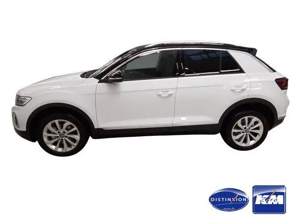 Profil droit d'un Volkswagen T-Roc blanc avec toit noir, version 2025, finition Style, roues alliage 17 pouces.