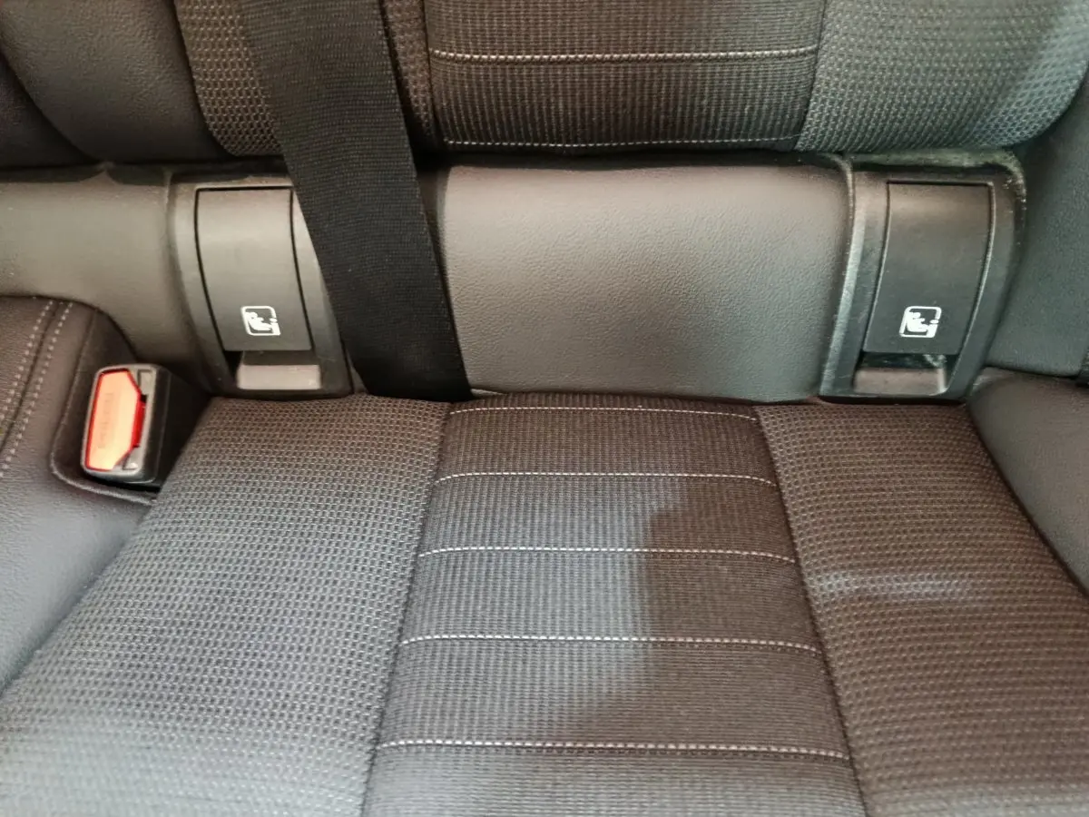 Détail de la banquette arrière noire avec ceintures et fixations Isofix visibles dans une BMW Série 3 318d Lounge.