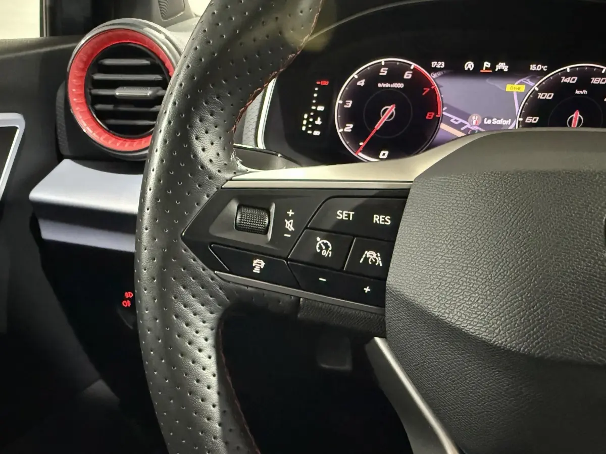 Gros plan sur le volant en cuir perforé avec commandes multifonctions et tableau de bord digital de la SEAT Ibiza 2024.