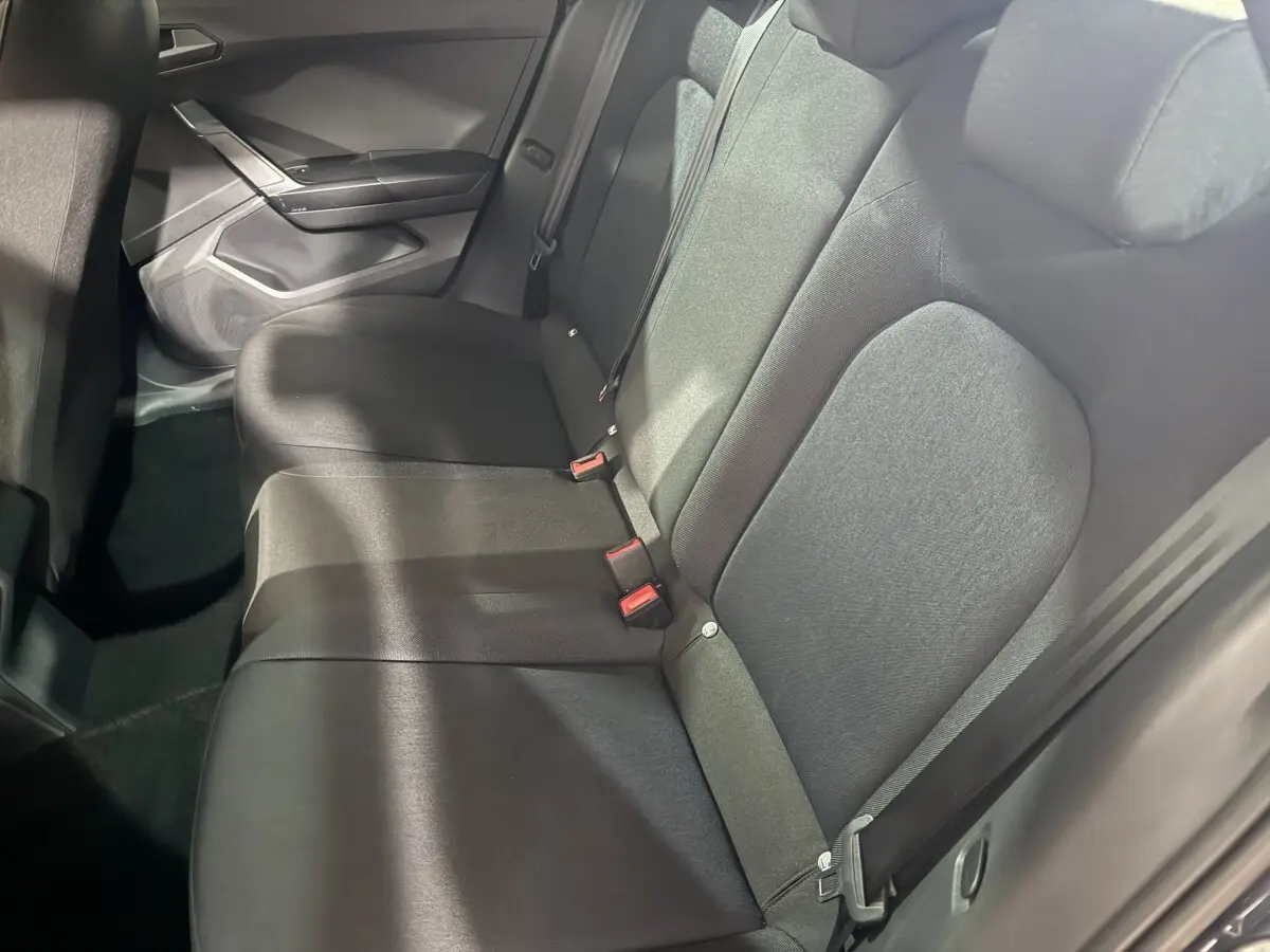 Vue intérieure du siège arrière droit de la SEAT Ibiza 1.0 TSI 110 FR 2024 en tissu gris foncé, avec ceinture de sécurité visible.