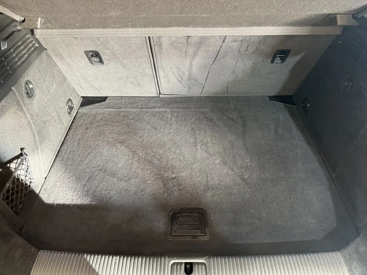 Vue plongeante sur le coffre spacieux et propre de l'Audi A3 2.0 TDI Business Line, revêtement gris foncé.