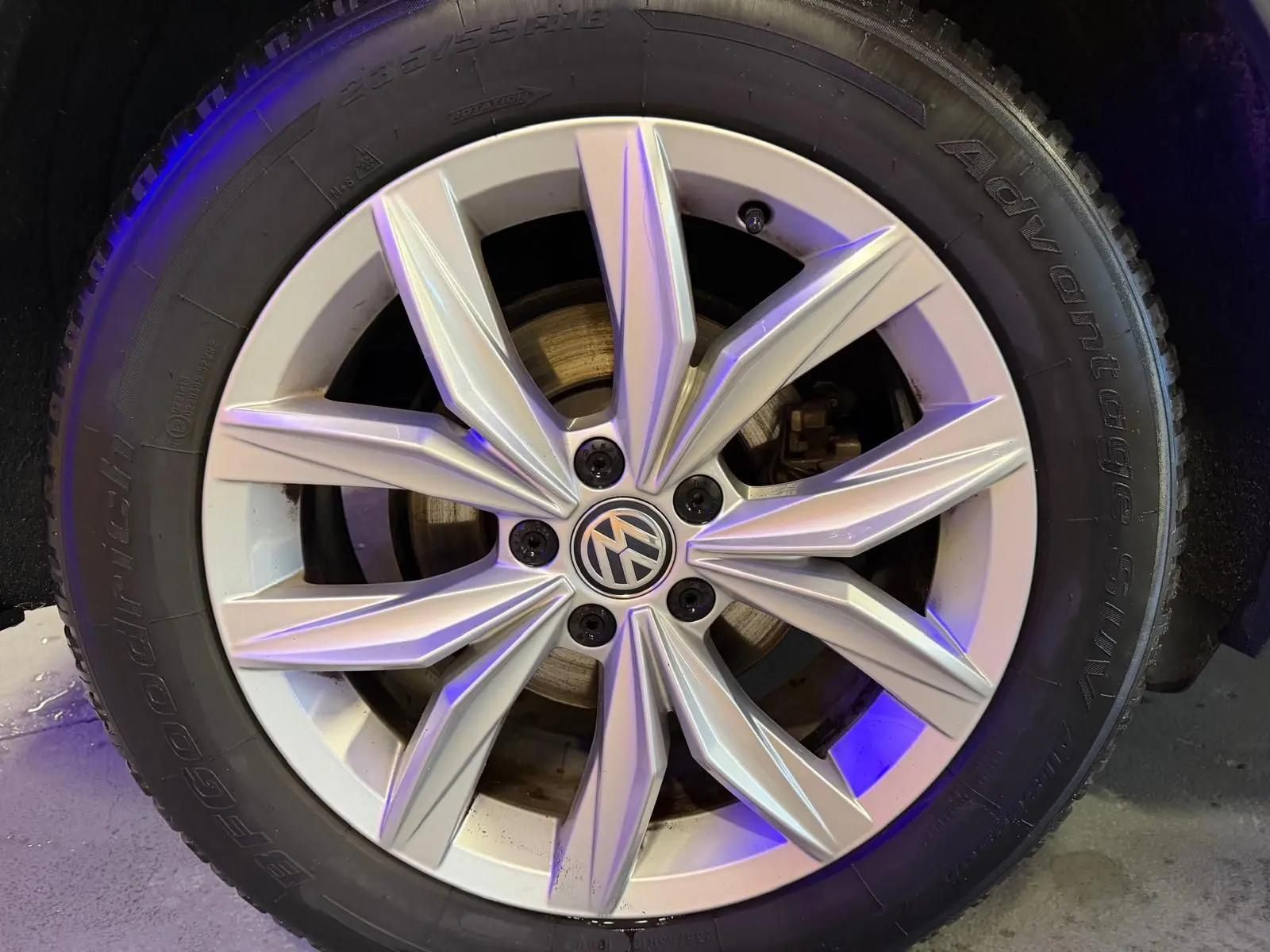 Gros plan sur la jante alu argentée d’un Volkswagen Tiguan gris, avec logo VW au centre et pneu BFGoodrich.