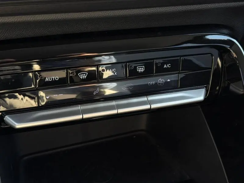 Gros plan sur les commandes de climatisation noires et argentées du tableau de bord de la Citroën C3 Gris Mercury 2025.