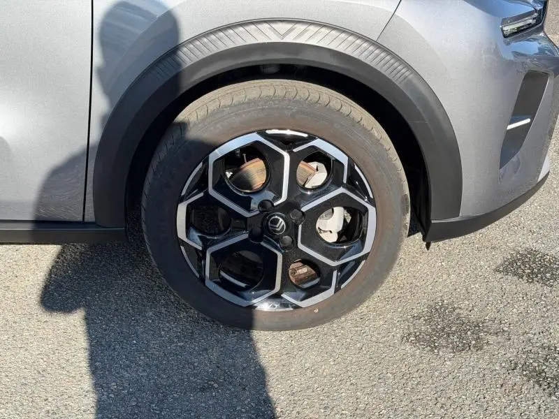 Gros plan sur la roue avant gauche de la Citroën C3 gris Mercury avec jante alu au design hexagonal.