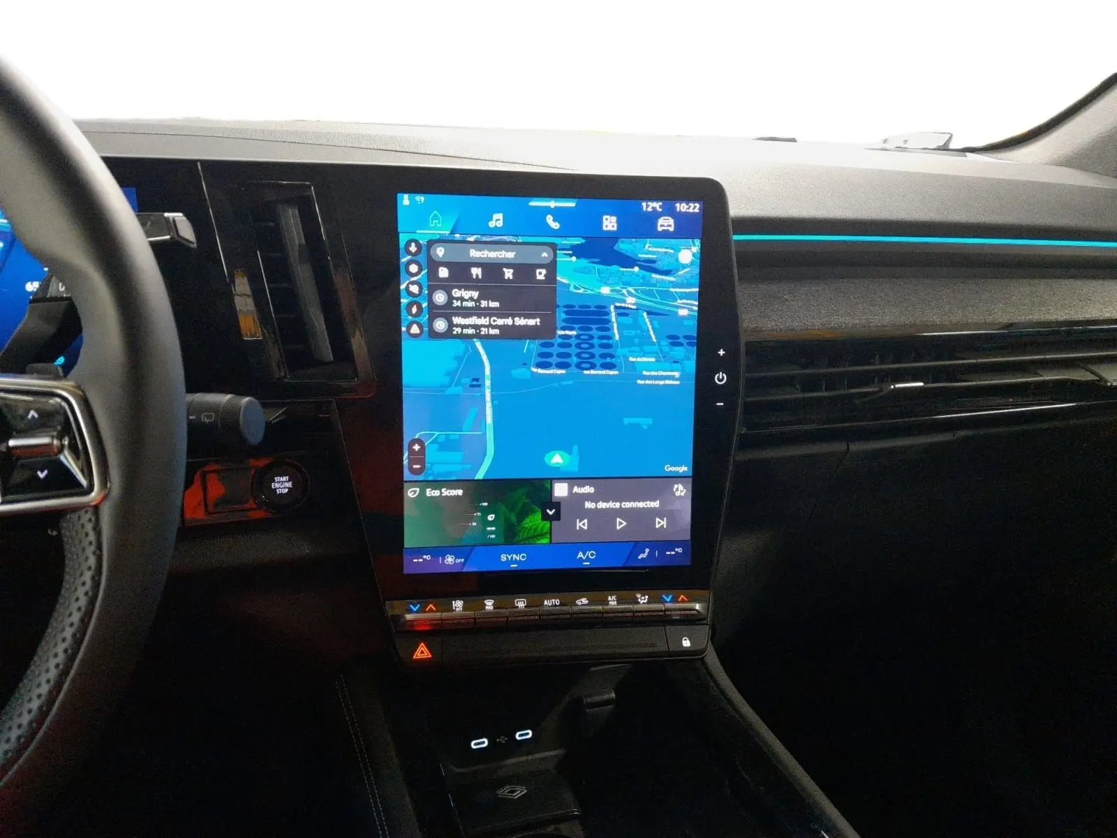 Vue intérieure du tableau de bord du Renault Espace 2025 avec écran tactile vertical et ambiance lumineuse bleue.