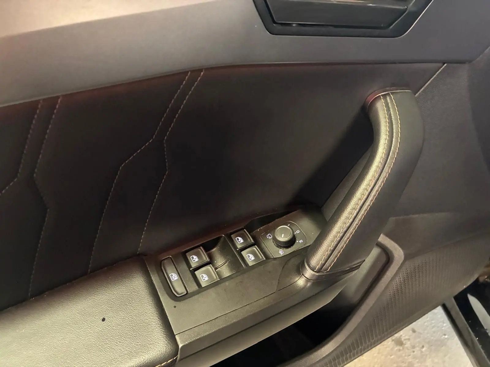 Gros plan sur la poignée de porte côté conducteur noire avec commandes des vitres et réglage des rétroviseurs du CUPRA Formentor 2022.