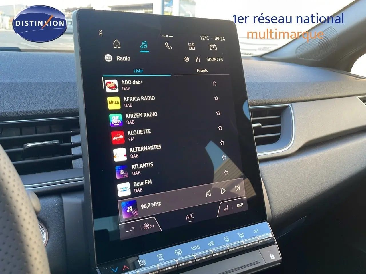 Vue rapprochée de l'écran tactile central du tableau de bord du Renault Captur gris cassiopée 2025 affichant les stations radio DAB.