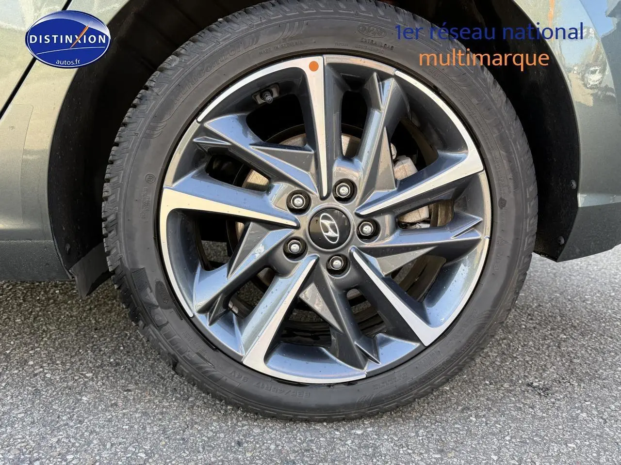 Gros plan sur la jante alu gris anthracite de la roue avant droite d'une Hyundai i30 2024 hybride.