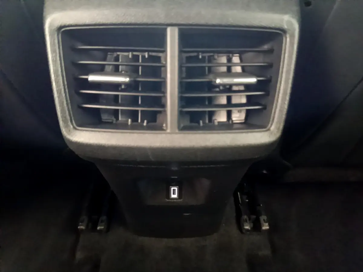 Gros plan sur les aérateurs arrière noirs et prise USB du Citroën C5 Aircross gris foncé, vue intérieure centrale.