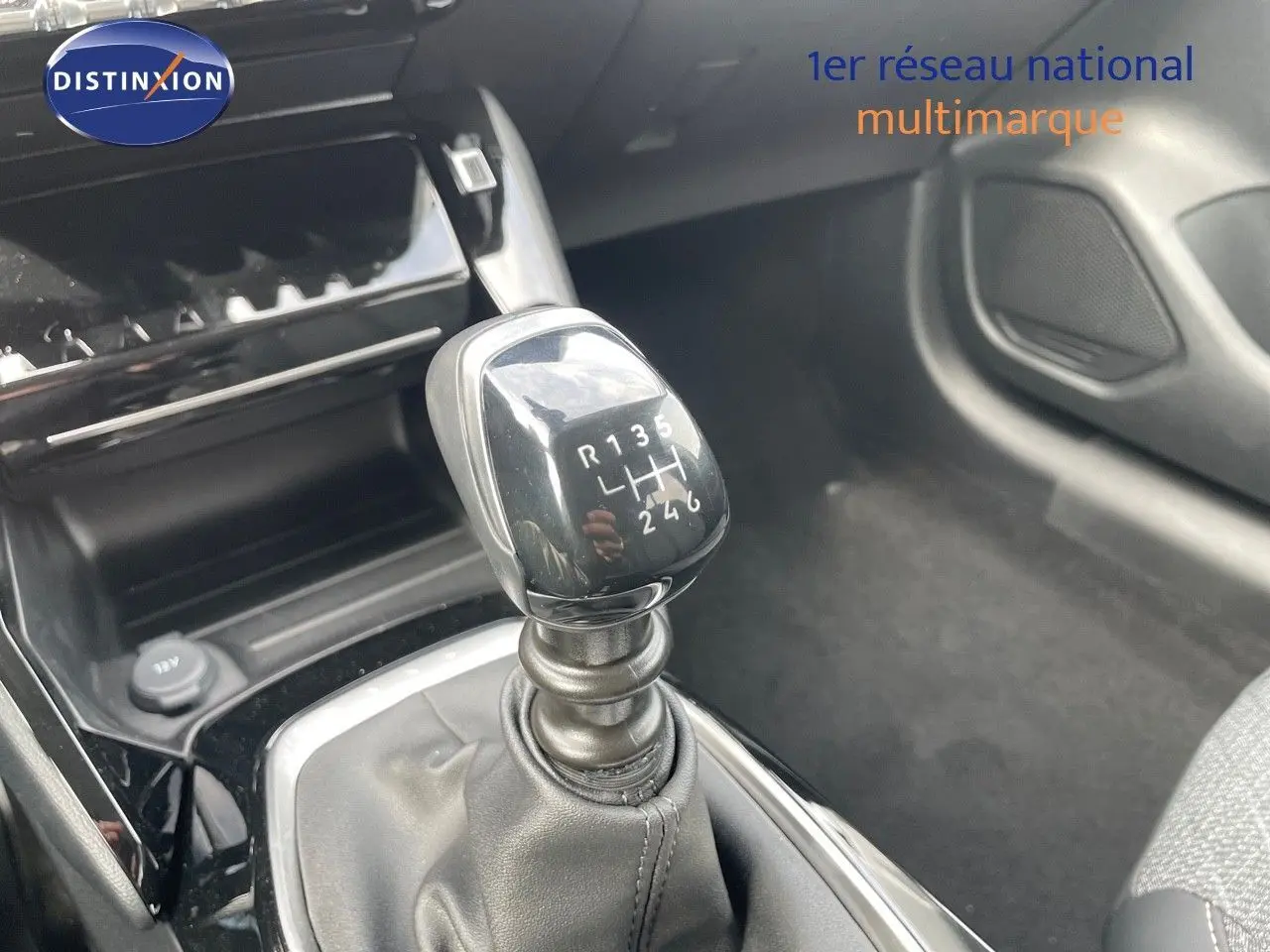 Le levier de vitesses manuel en gros plan dans l'habitacle d'une Peugeot 208 jaune Agueda Metal.