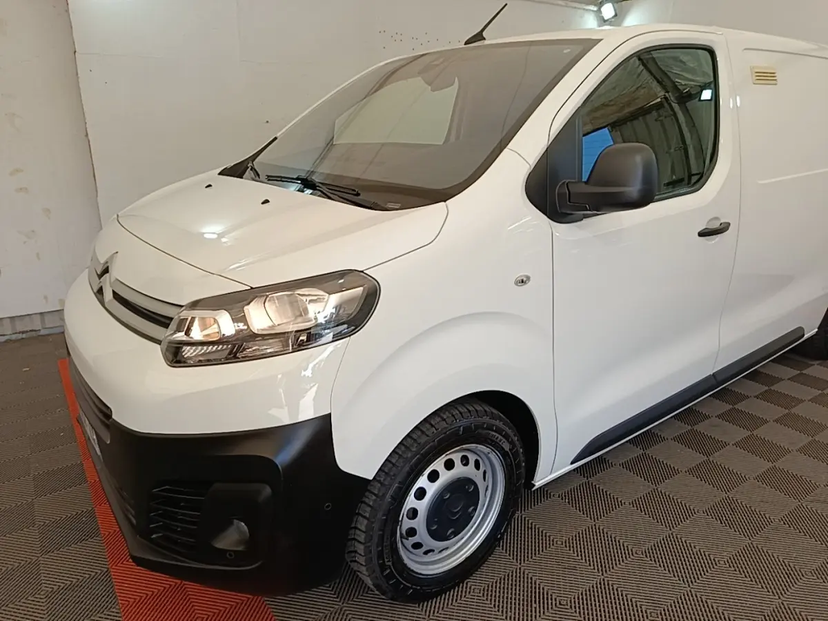 Vue 3/4 avant droit d'un Citroën Jumpy blanc avec pare-chocs noir et jantes acier en intérieur.