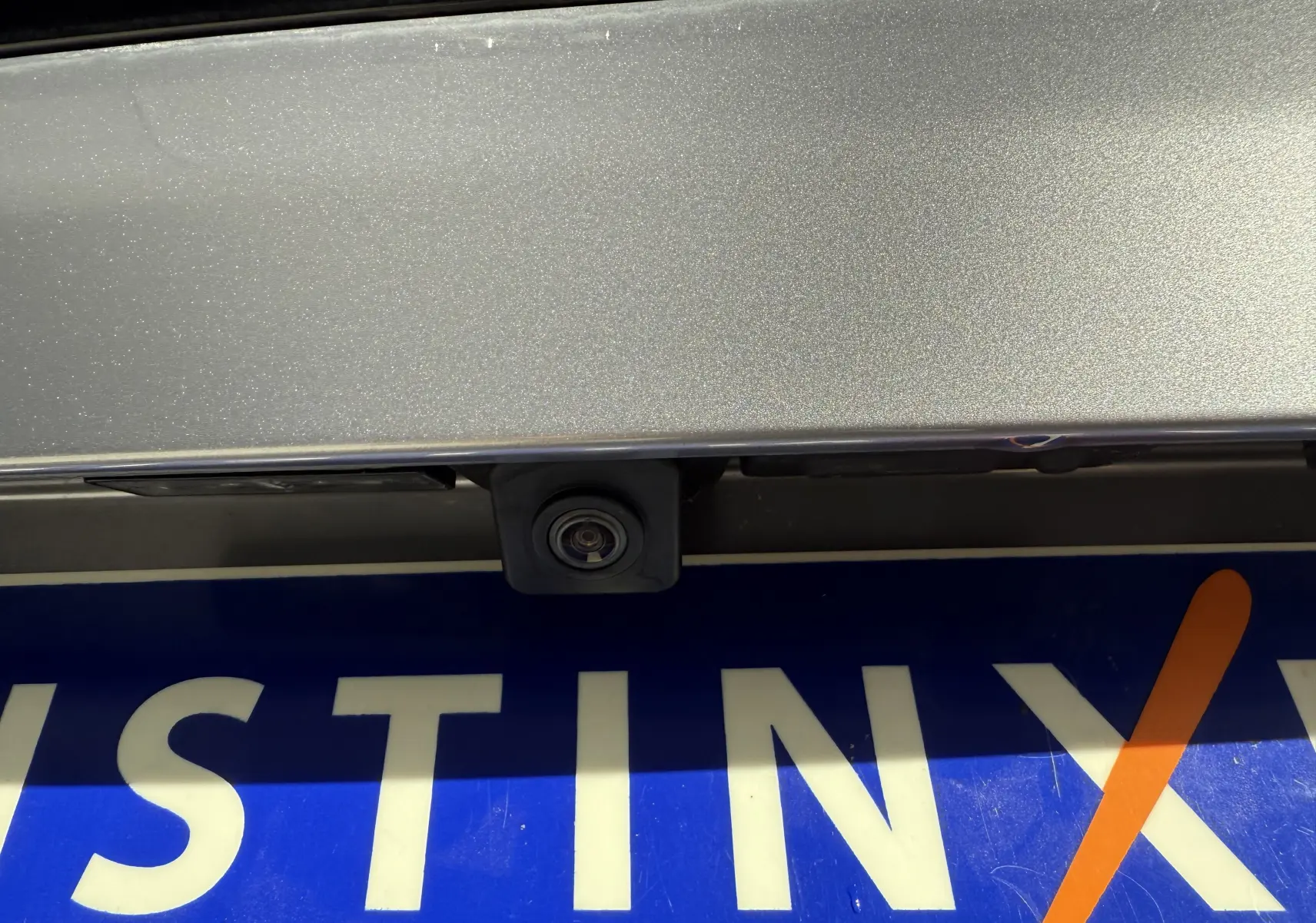 Gros plan sur la caméra de recul intégrée au hayon gris Artense métal du Peugeot 3008 2023.