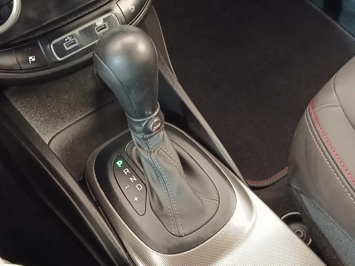 Gros plan sur la commande de boîte automatique noire de la FIAT 500X 2021, avec coutures apparentes et console grise texturée.