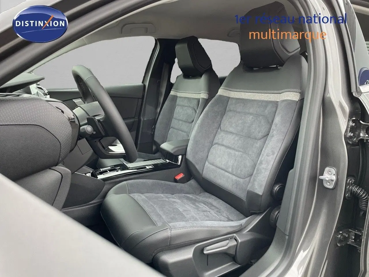 Vue intérieure côté conducteur de la Citroën C4 2024 gris platinium, sièges en cuir noir et alcantara gris.