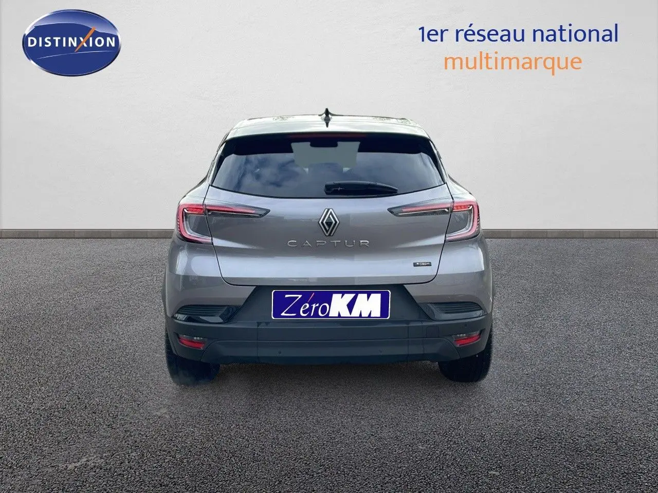 Vue arrière d'un Renault Captur gris cassiopée métal avec toit noir, affichant ses feux LED et logo central.