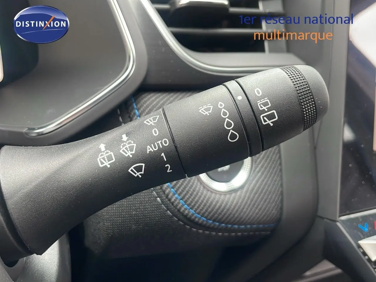 Gros plan sur la commande des essuie-glaces dans l'habitacle du Renault Captur E-Tech hybride bleu iron metal.