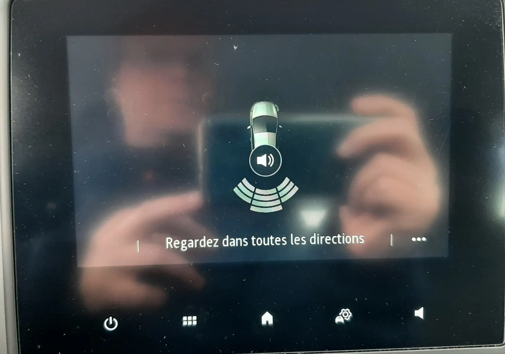 Écran central de la Renault Clio V blanc affichant l'alerte de détection d'obstacles avec icône sonore.